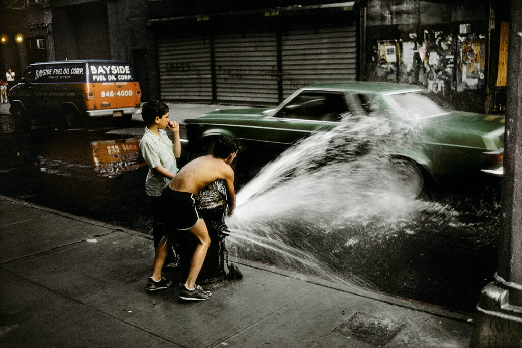 USA. New-York City. Childrens playing with Fire hydrant. 1985.
